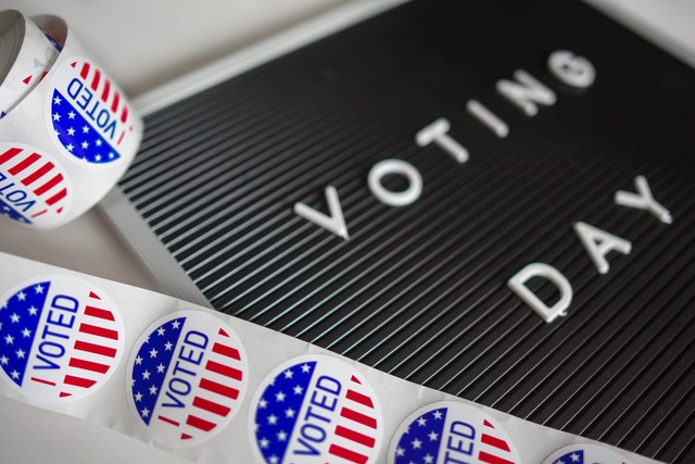 'Voting Day' sign with 'I VOTED' stickers
