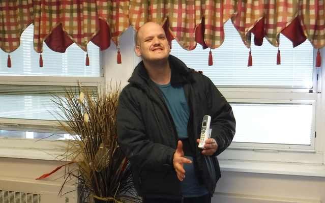 James holds the telephone he used to call Disability Rights Ohio's voter hotline.
