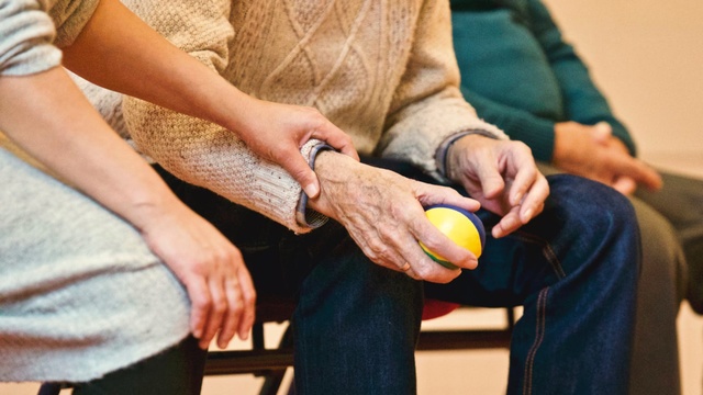 Older man holding a ball