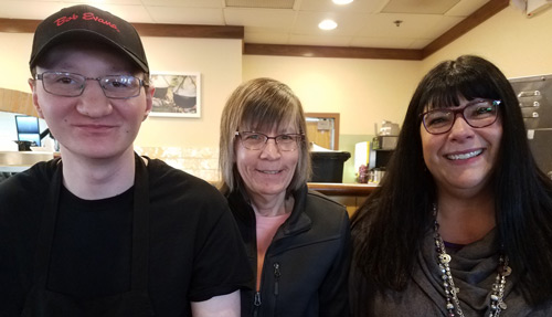 Zach Ricker and his mom, Lorie, stand next to DRO Attorney Kristin Hildebrant at the Bob Evans restaurant in Bellefontaine, where Zach works 